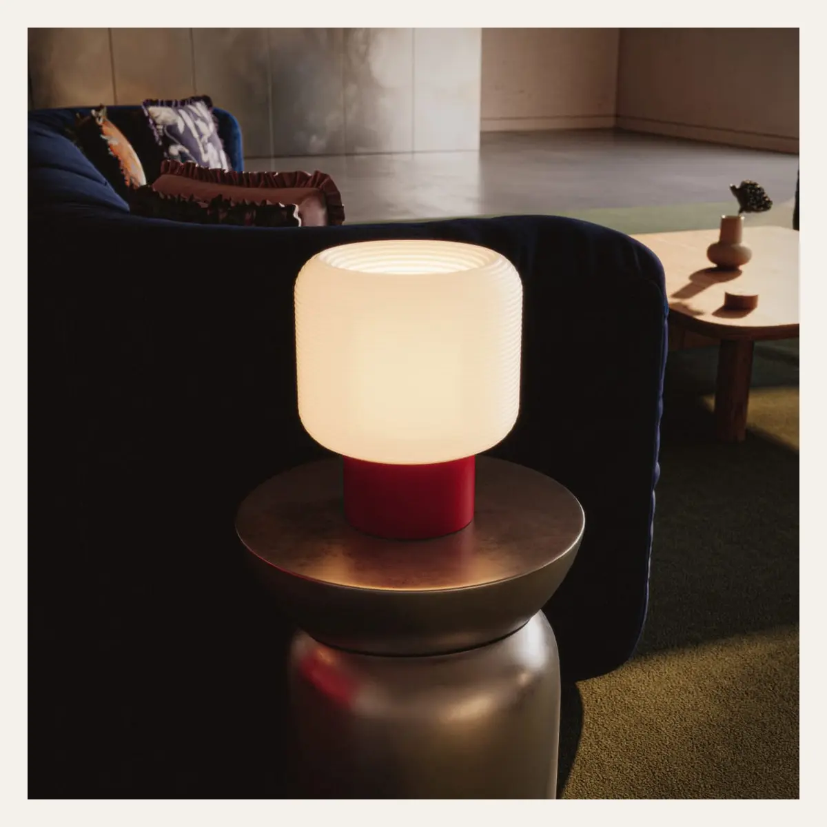 A glowing table lamp in a dark, calm interior.